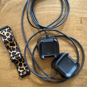 Two Fitbit (versa) chargers, elastic wristband.